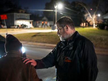 Charlie Leavitt, director of Metro Relief, talks with a man near the corner of Metropolitan...