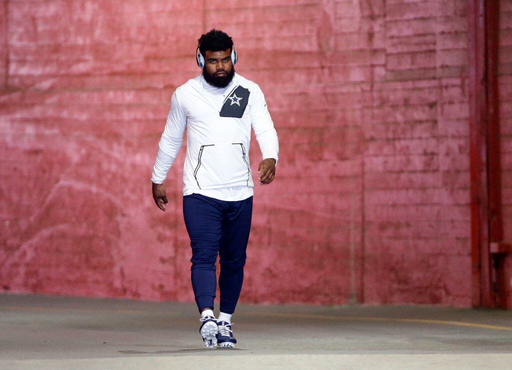 Dallas Cowboys running back Ezekiel Elliott (21) makes his way to the field to warmup before...
