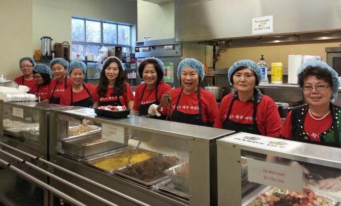 
Members of the Korean American Women's Association of Dallas serve Korean food at Center of...