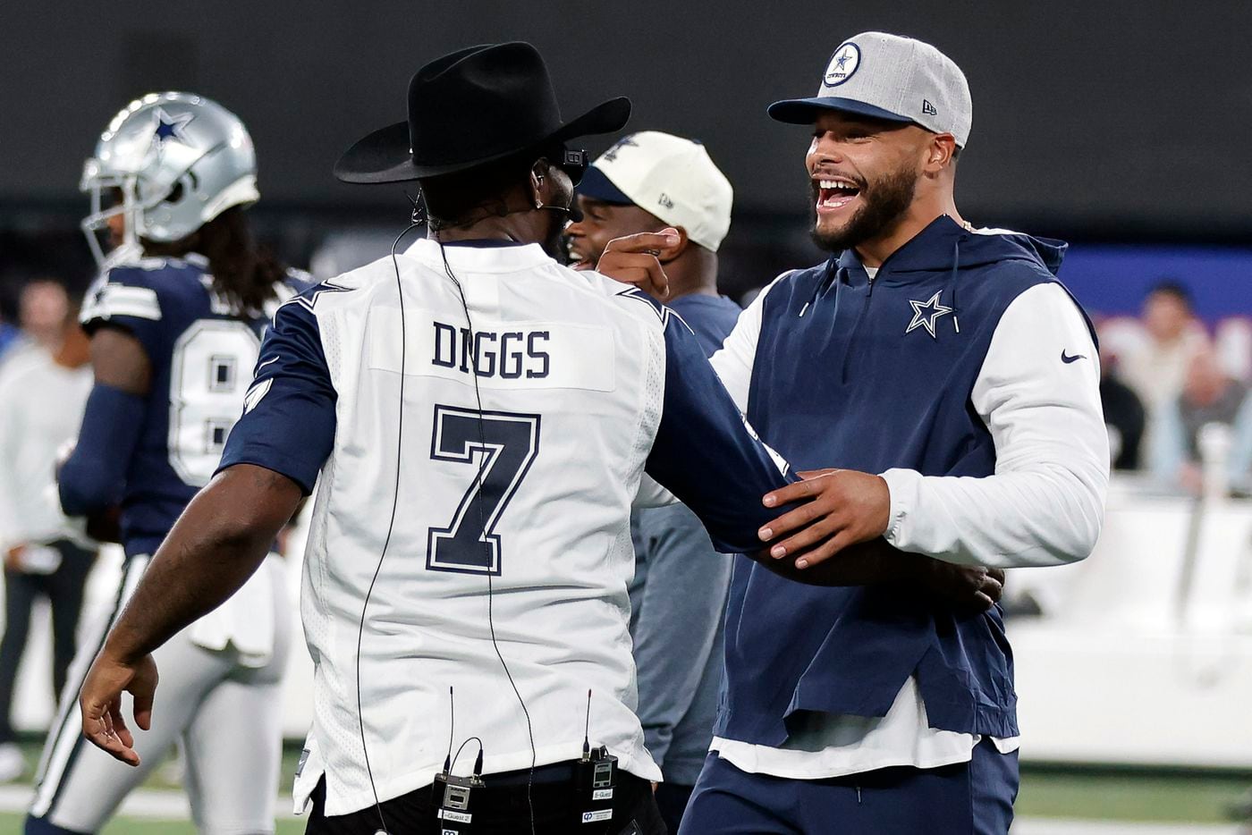 Dallas Cowboys quarterback Dak Prescott (right) is greeted by former Cowboy Dez Beyant...