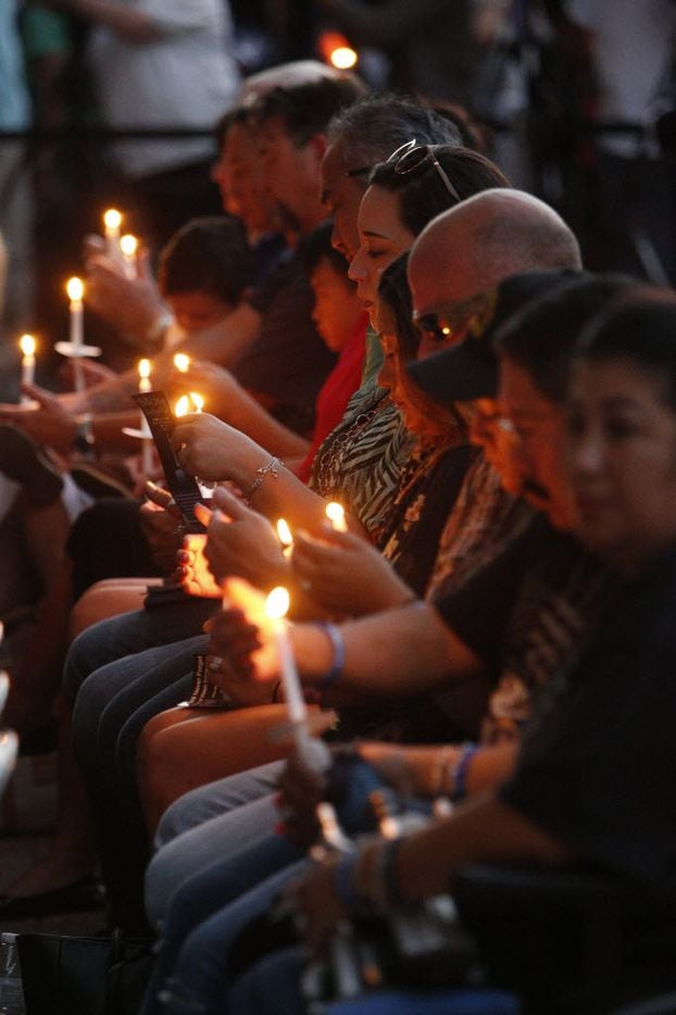 Family members of the police shootings light candles during the candlelight vigil hosted by the Dallas Police Association at Dallas City hall in Dallas, TX July 11, 2016. (Nathan Hunsinger/The Dallas Morning News)