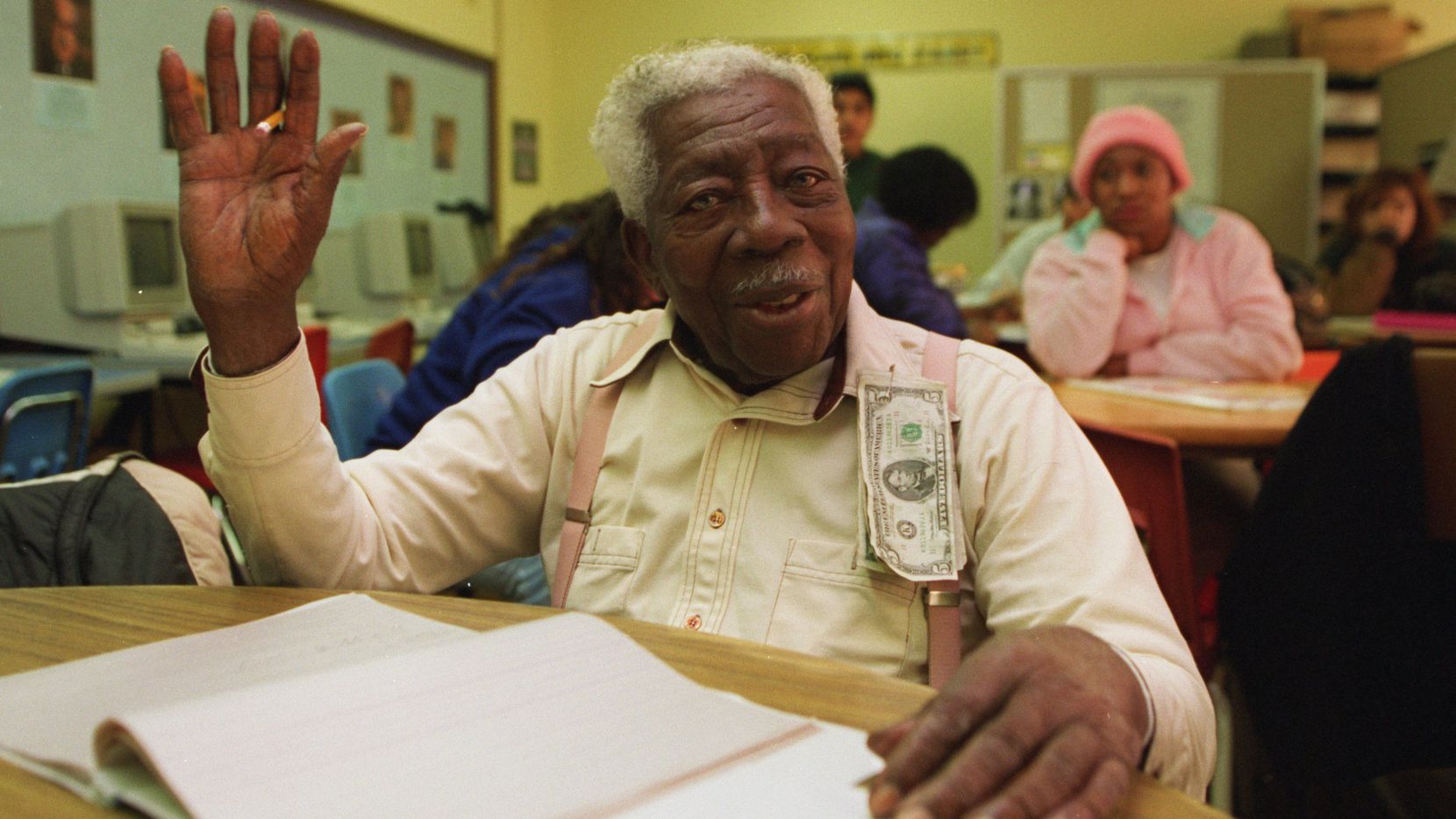 Then-98-year-old George Dawson gestures after receiving much attention during class before...