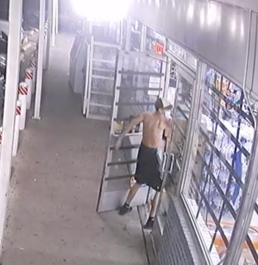 A framegrab from a surveillance video showed a thin, shirtless teen opening the front door...
