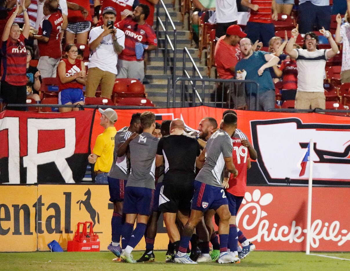 FC Dallas forward Paul Arriola (7) is mobbed by team mates after scoring a goal during the...