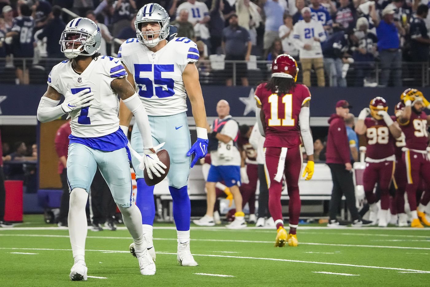 Dallas Cowboys cornerback Trevon Diggs (7) celebrates with outside linebacker Leighton Vander Esch (55) after intercepting a pass intended for Washington Football Team wide receiver Terry McLaurin during the first half of an NFL football game at AT&T Stadium on Sunday, Dec. 26, 2021, in Arlington.