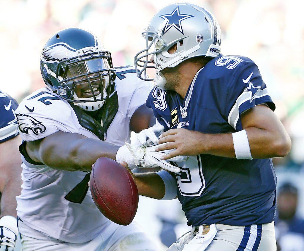 Quarterback Tony Romo #9 of the Dallas Cowboys is sacked by Cedric Thornton #72 of the...