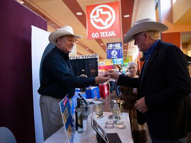 Todd Gregory, of Black Eyed Distilling Company, gives samples of vodka at the Go Texan...
