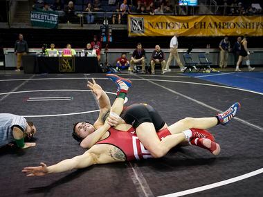 Cary Palmer of Temple (facing) is pinned by Carter Weeks of Iowa State in a 149 lbs...