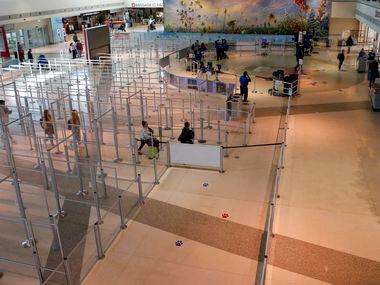 A group of travelers make their way through a mostly empty TSA security checkpoint at Love...