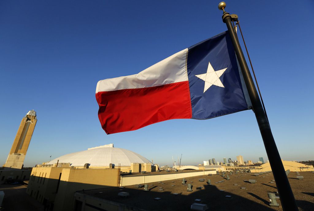 The Texas flag waves above the Pioneer Tower (from left), Will Rogers Memorial Coliseum and...