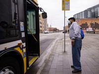 Kenneth Mosley asks a bus driver for help as he looks for DART route 16 on Monday. DART's bus redesign launched today and almost every bus route has changed in an attempt to increase ridership and decrease waiting times.