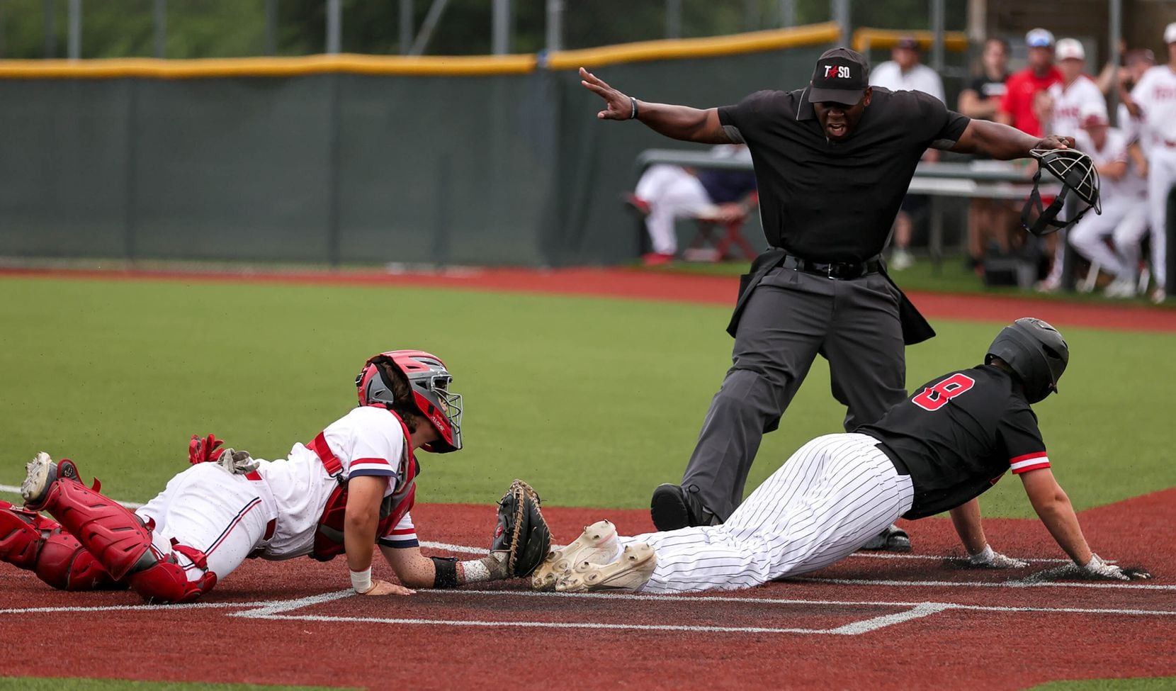 Mansfield Legacy DH Cade Sanberg (left) is called safe at home plate as Justin Northwest...
