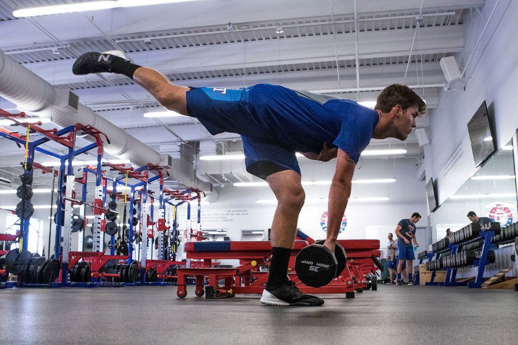 Texas Rangers' pitcher Cole Ragans works on his balance and strength at the Rangers'...