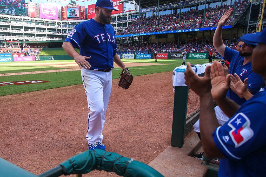 Texas Rangers starting pitcher Lance Lynn (35) is congratulated by his teammates after...