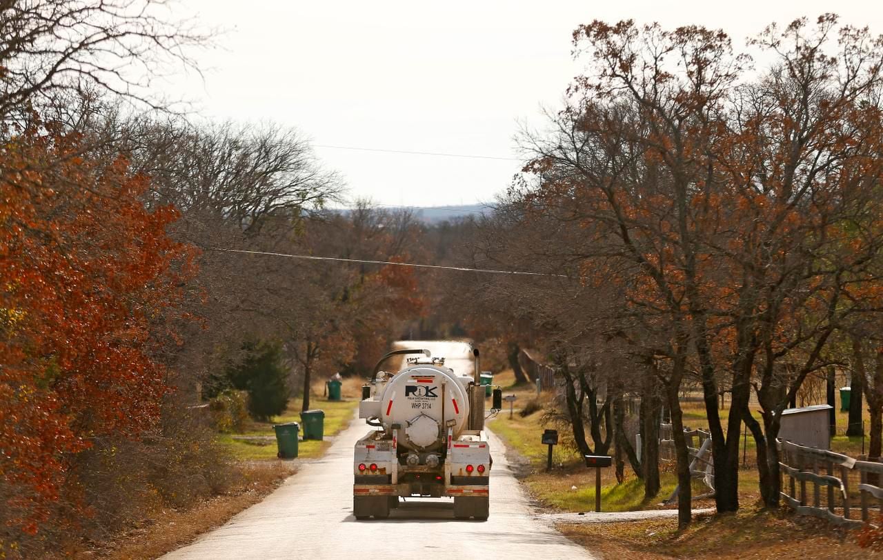 A truck hauling wastewater from gas drilling operations drives through a rural Parker County...