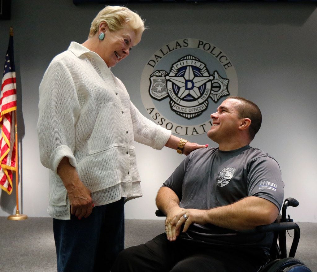 DART Detective Justin Ellis is greeted by Maurine Dickey, founder and chairwoman of...