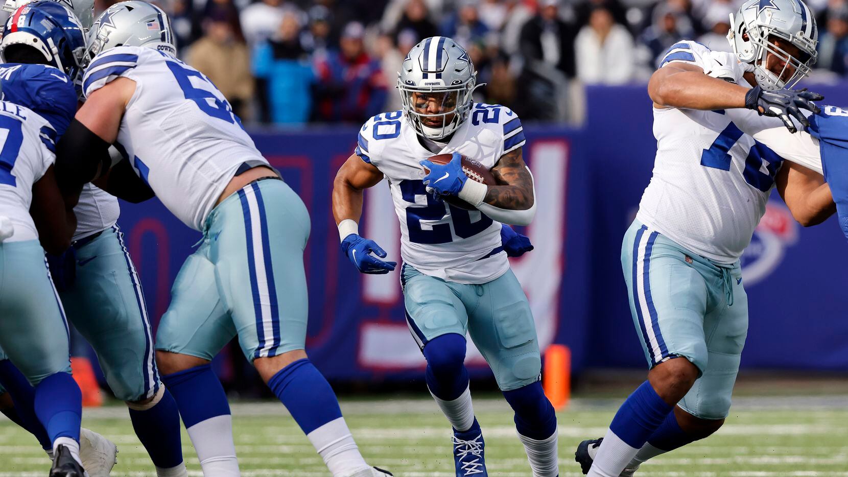 Dallas Cowboys running back Tony Pollard (20) carries the ball through a big hole in the...