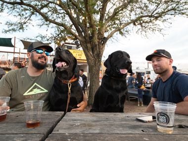 Louis Perez, left, with his dog Goose, and their buddies Bingham and Michael Swayne, have a...