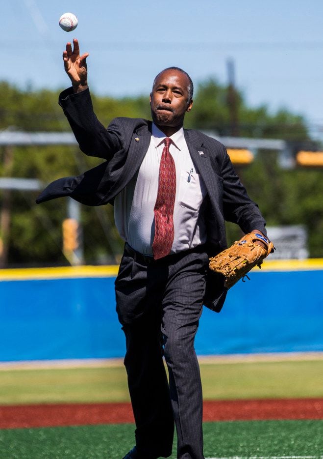 U.S. Secretary of Housing and Urban Development Ben Carson throws the opening pitch before a...