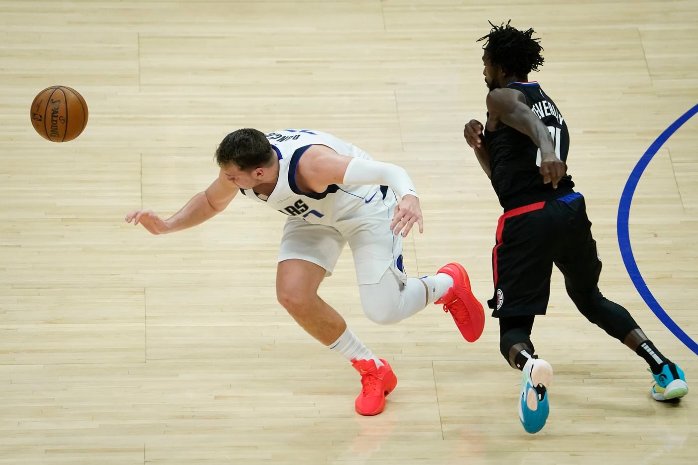 Dallas Mavericks guard Luka Doncic (77) has the ball stolen by LA Clippers guard Patrick Beverley (21) during the first half of an NBA playoff basketball game at Staples Center on Tuesday, May 25, 2021, in Los Angeles.