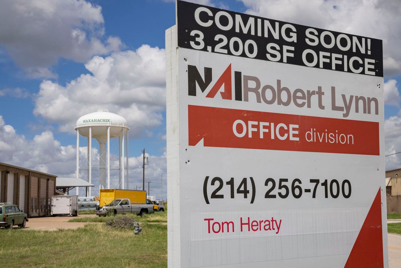 A Waxahachie water tower seen behind a coming soon office sign on Monday, Aug. 29, 2022, in...
