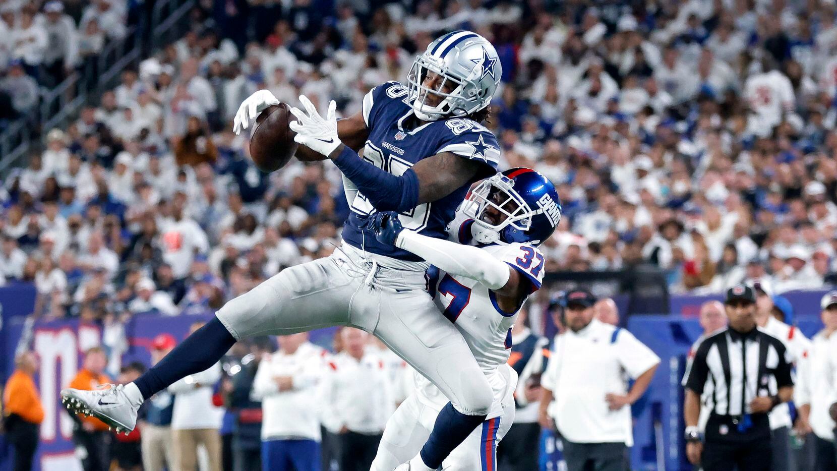 Dallas Cowboys wide receiver Noah Brown (85) goes high over New York Giants cornerback...