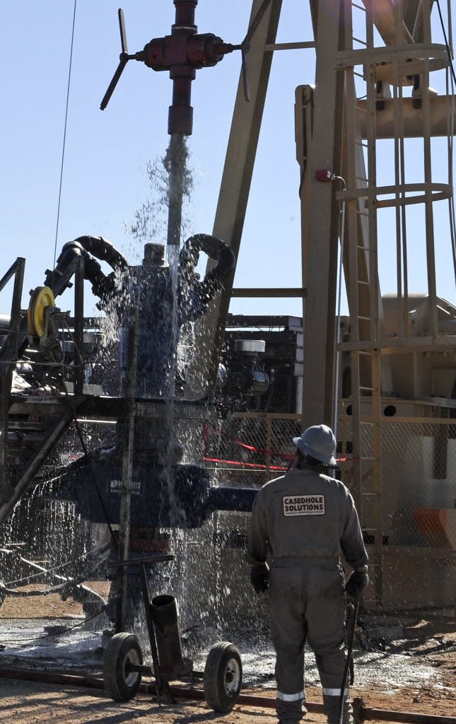 Water gushes out of a drilling pipe as it is pulled up to be replaced with a fresh pipe at a hydraulic fracturing site in Midland in 2013. The drilling method known as fracking uses huge amounts of high-pressure, chemical-laced water to free oil and natural gas trapped deep in underground rocks.