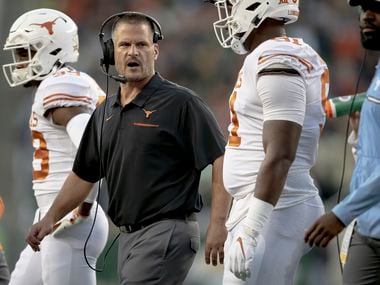Texas defensive coordinator Todd Orlando, second from left, talks with his players during an NCAA college football game against Baylor Saturday, Nov. 23, 2019, in Waco, Texas.