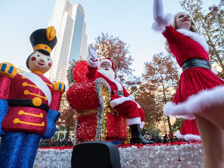 Santa Claus waves to parade goers during the Dallas Holiday Parade in downtown Dallas, on...