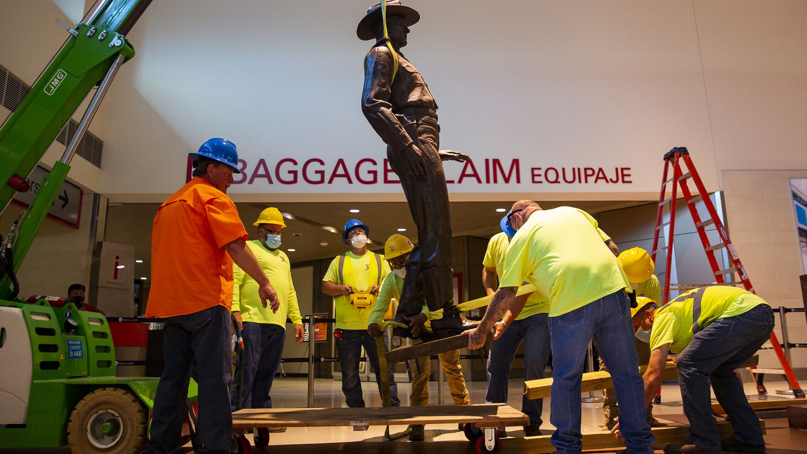 A Phoenix 1 Restoration & Construction crew removes 'One Riot, One Ranger' by Waldine Tauch...