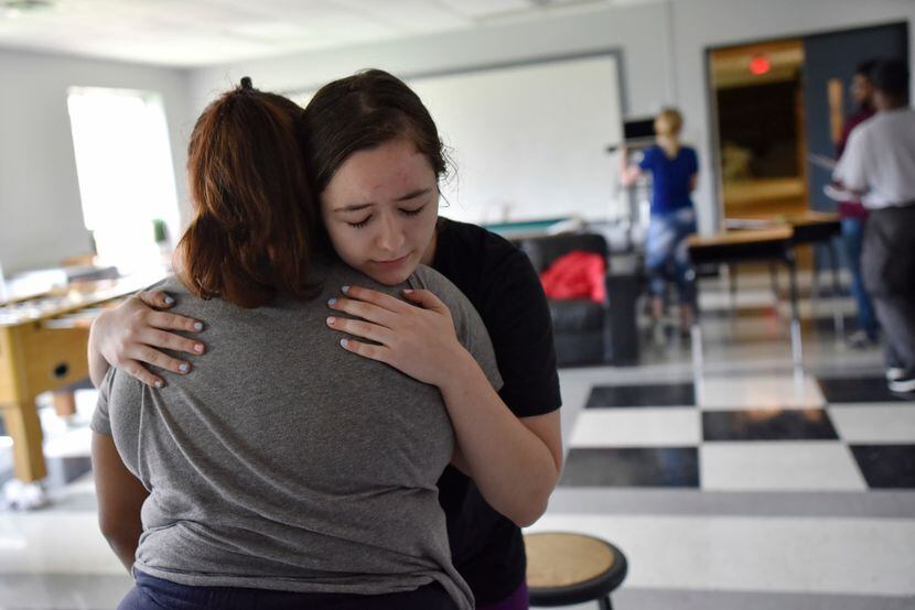 Emma Burkey, 16, (right) hugs Cicsy Rojas, 17, during a rehearsal of Sex Ed.
