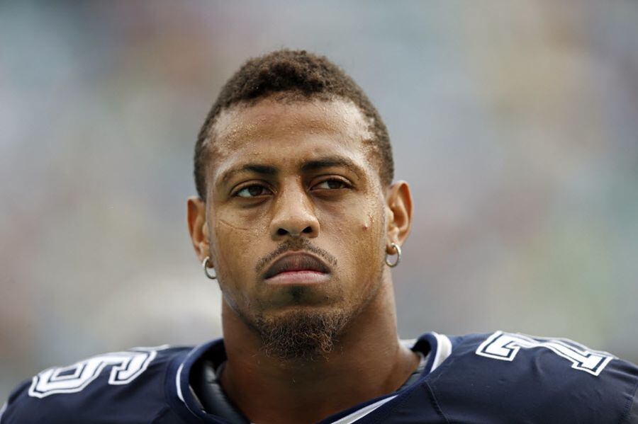Dallas Cowboys defensive end Greg Hardy looks on from the sidelines during the first half...