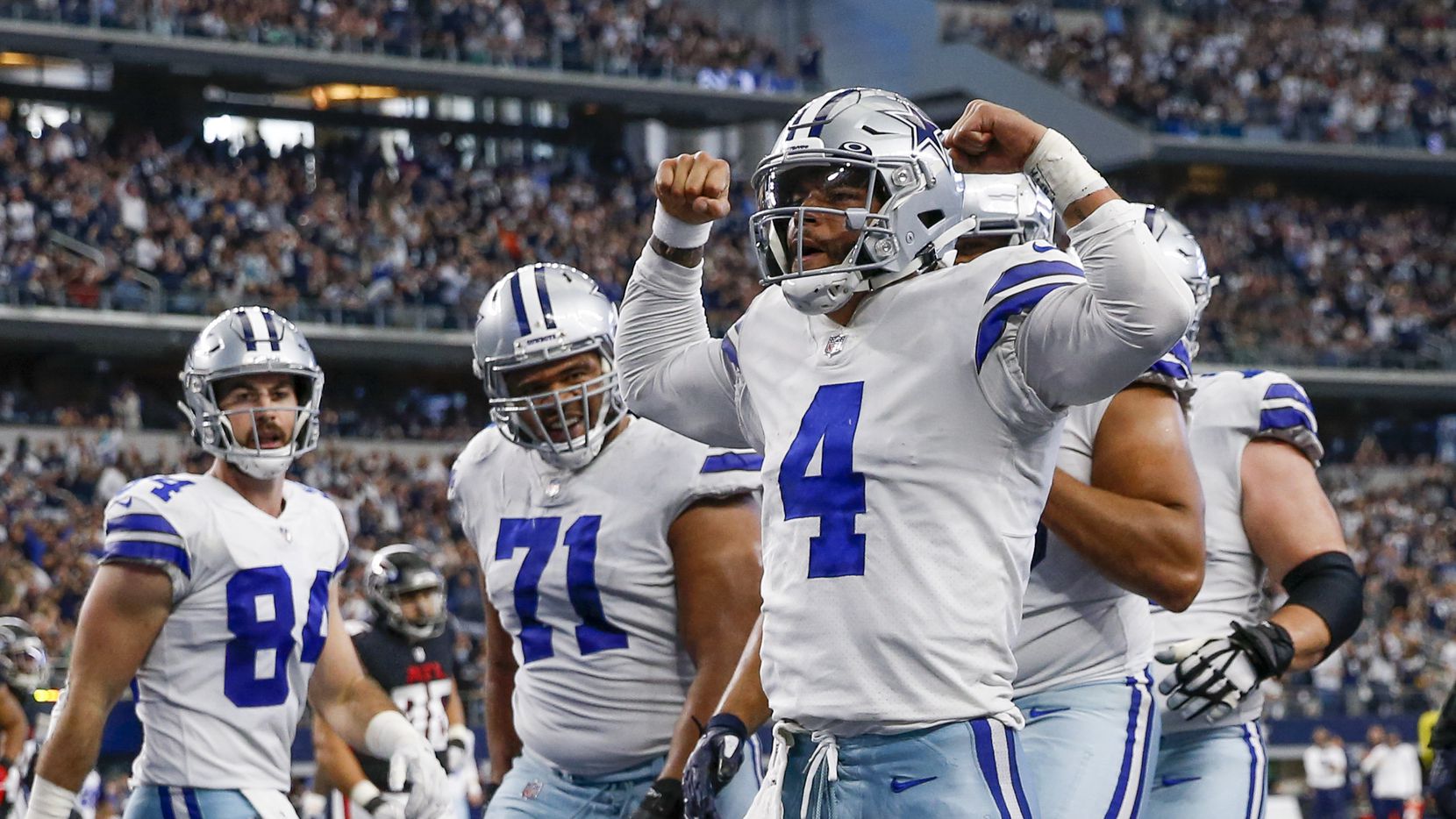 Dallas Cowboys quarterback Dak Prescott (4) flexes after scoring a touchdown during the second half of an NFL football game against the Atlanta Falcons at AT&T Stadium on Sunday, Nov. 14, 2021, in Arlington.