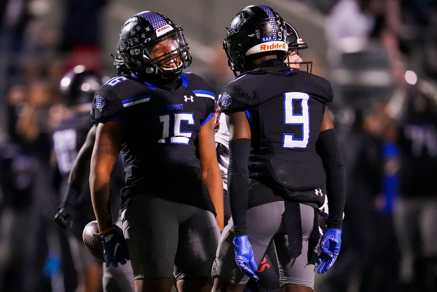 Mansfield Summit defensive back Justyn McDonald (15) celebrates with defensive back Tavare Smith Jr. (9) after intercepting a pass during the first half of the Class 5A Division I Region I final against Colleyville Heritage on Friday, Dec. 3, 2021, in North Richland Hills, Texas. (Smiley N. Pool/The Dallas Morning News)