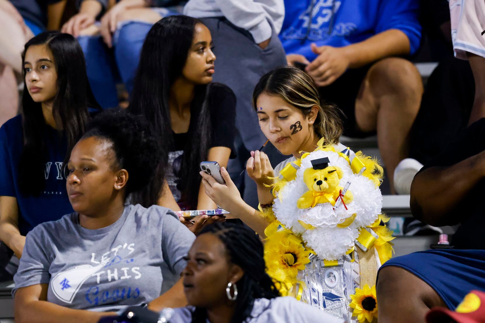 A North Forney student applies face paint during a District 10-6A football game against...