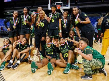 The DeSoto team poses with the Class 6A state championship trophy after defeating South...