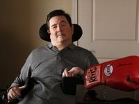 Kent Waldrep poses for a portrait with a boxing glove signed by Muhammad Ali at his home in...
