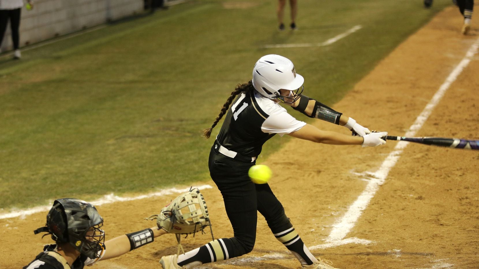 The Colony High School #11, Olivia Wick, gets a strike during a softball game against Frisco...
