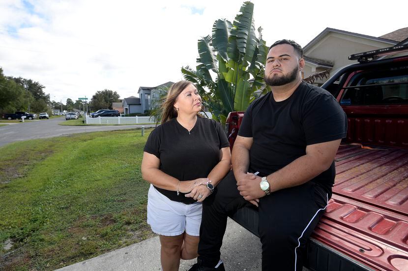 Brandon Gonzales sits on the back of his stepfather's truck with his mother, Pam Lopez, by...