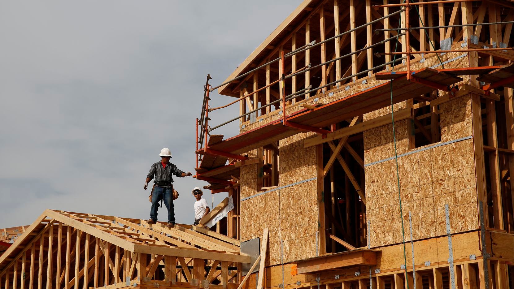 Workers frame new homes at a Toll Brothers Inc. community in California.