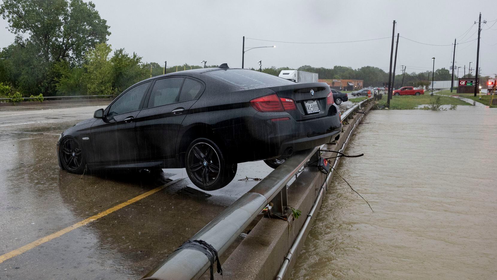 A BMW sets on the rail overlooking the flooded South Mesquite River on Monday, Aug. 22,...