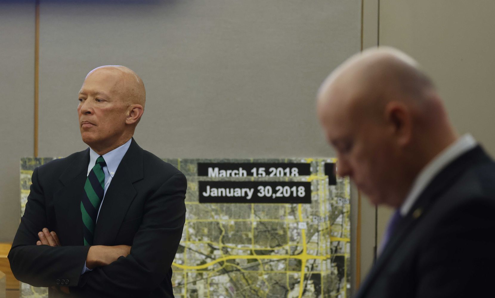 District Attorney John Creuzot (left) and District Attorney Glen Fitzmartin wait during a break for...