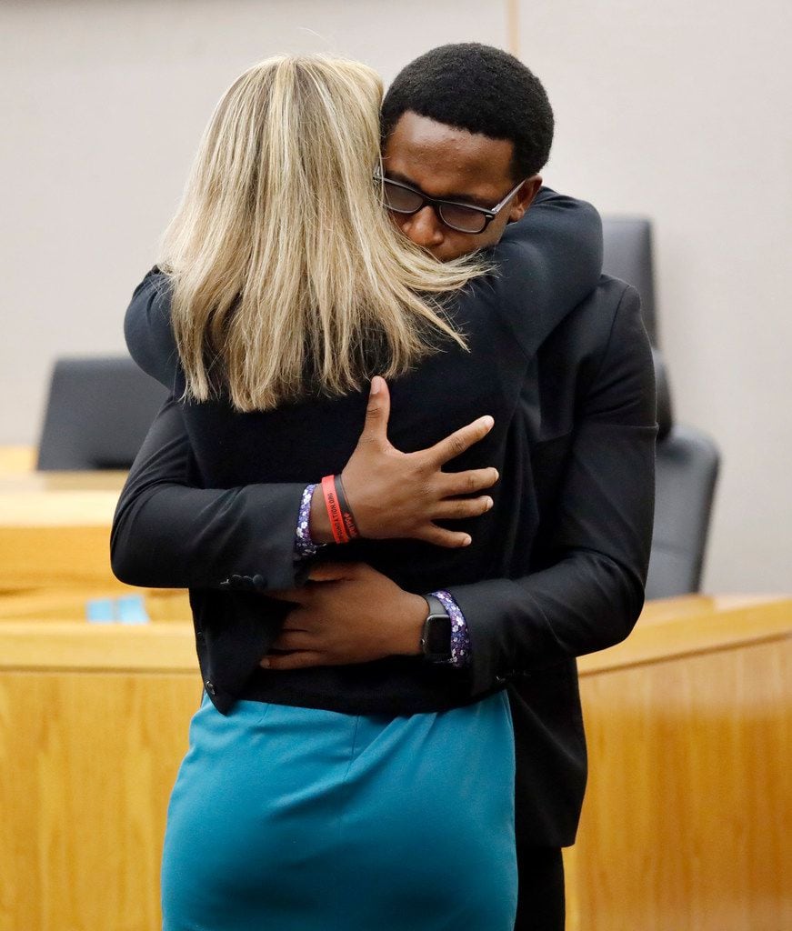 Botham Jean's younger brother Brandt Jean hugs Amber Guyger after a jury sentenced her to 10...