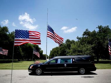 The hearse passes in the funeral procession for the burial for fallen Dallas police officer...