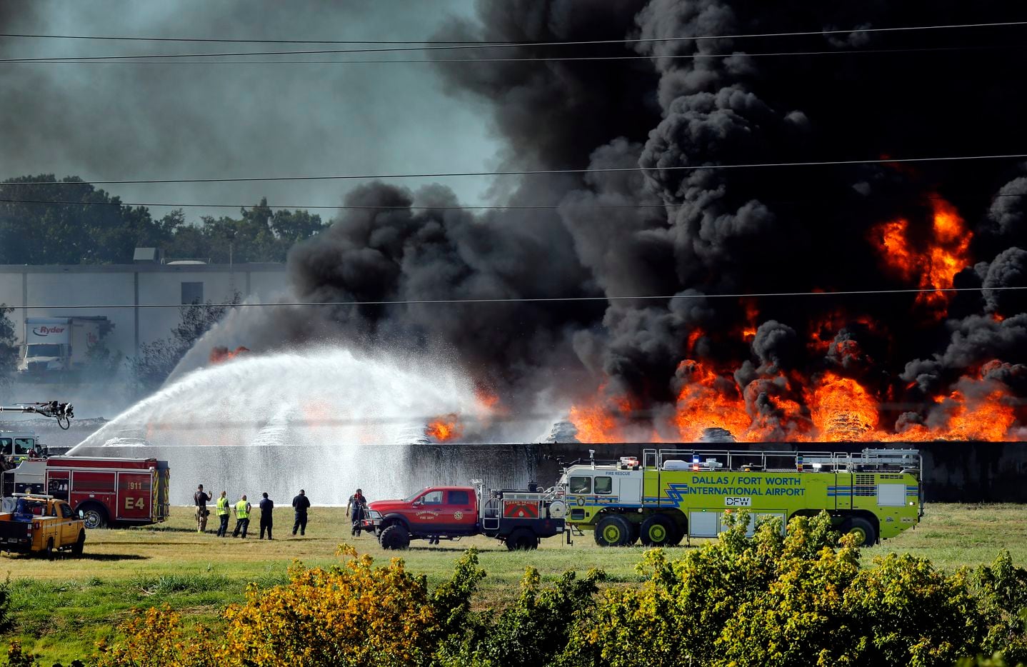 Grand Prairie and DFW International Airport firefighters douse burning plastic which caught fire at Poly-America at 2000 West Marshall Drive in Grand Prairie, Texas, Wednesday, August 19, 2020.