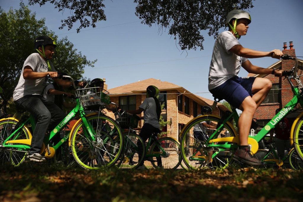 Townview Magnet Center physical education students ride Lime bikes  along Blaylock Drive and Colorado Boulevard in the Lake Cliff Historic District in the Oak Cliff. 