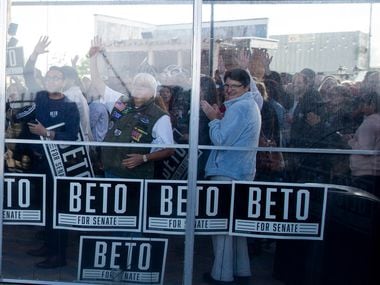 Supporters wave as Congressman Beto O'Rourke arrives to campaign at Lava Cantina in The...