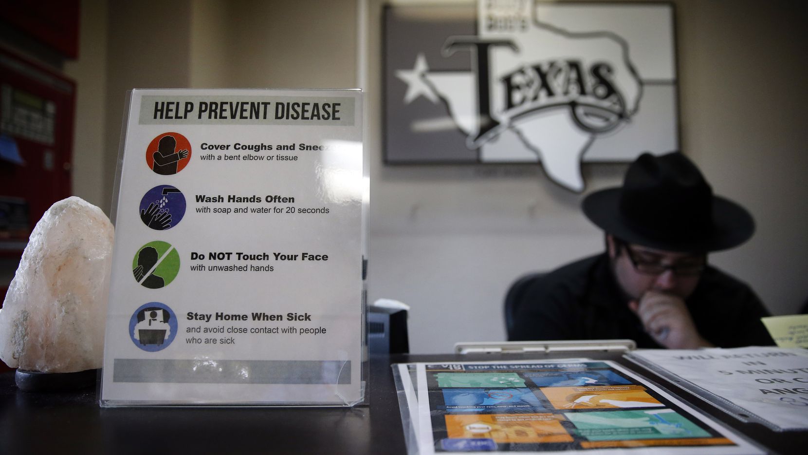 Signage reminds employees to help control the spread of COVID-19 at the employee entrance of Billy Bob's Texas in Fort Worth, Wednesday, August 5, 2020.