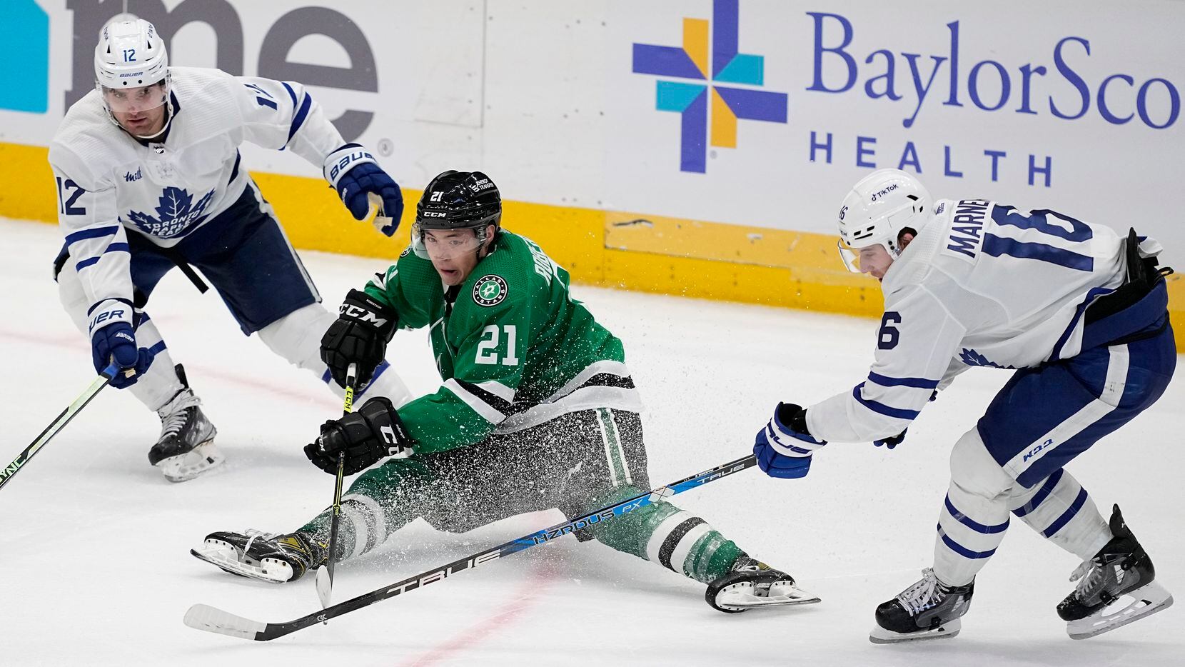 Dallas Stars left wing Jason Robertson (21) loses control of the puck under pressure from...