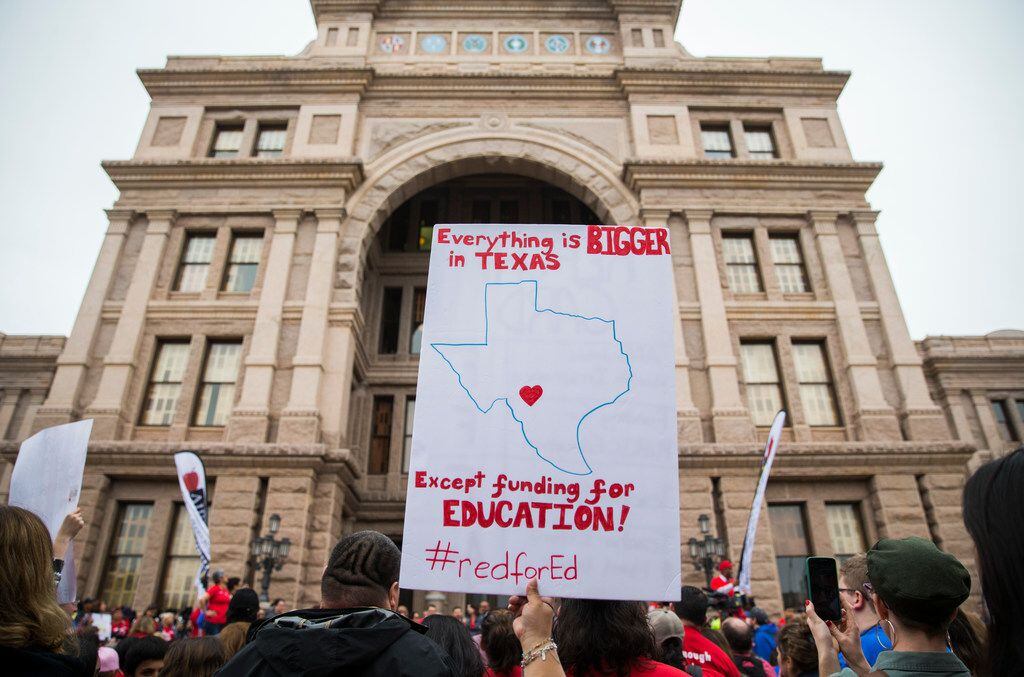 Educators and supporters hold signs and gather during the Texas Public Education Rally on...